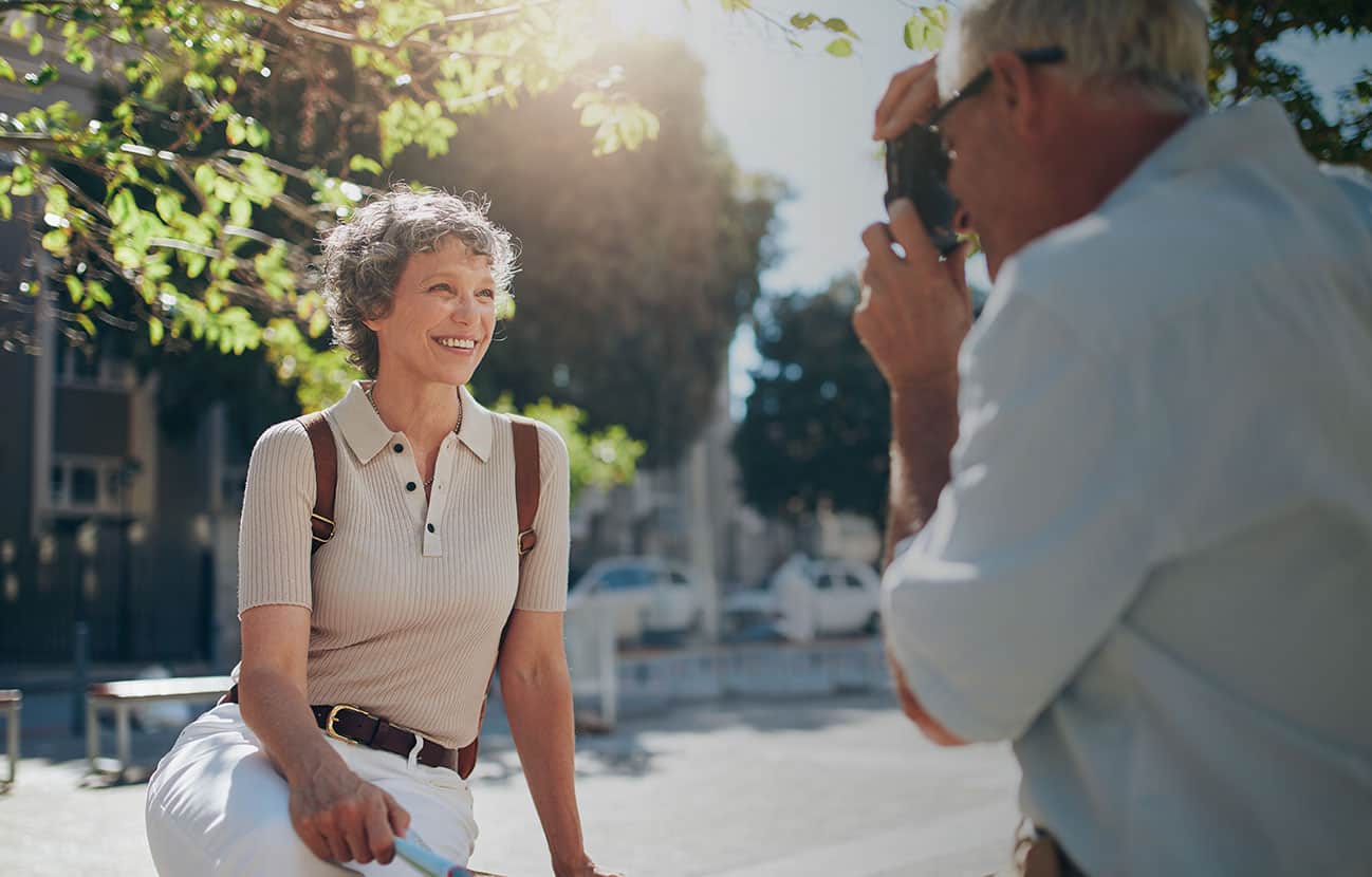 older couple in city taking picture